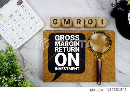 GMROI Gross Margin Return On Investment text with calculator, magnifying glass and alarm clock on marble background 139381245