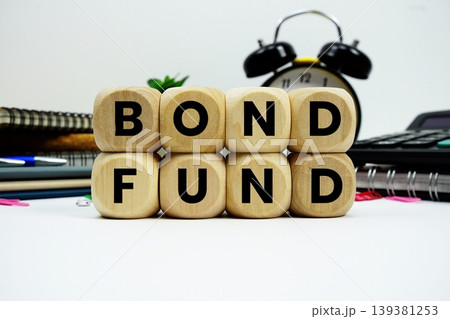Bond Fund alphabet letters with calculator and alarm clock on white background Bond Fund alphabet letters with calculator and alarm clock on white background 139381253