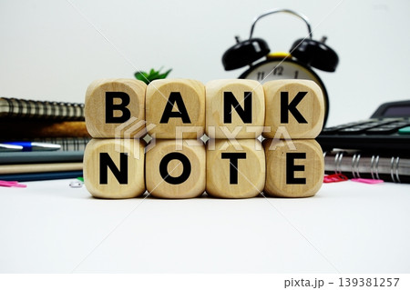 Bank Note alphabet letters with calculator and alarm clock on white background 139381257