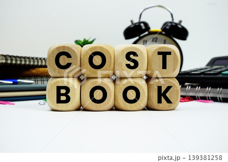 Cost Book alphabet letters with calculator and alarm clock on white background Cost Book alphabet letters with calculator and alarm clock on white background 139381258