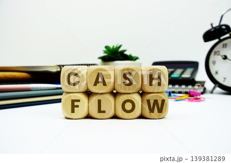 Cash Flow alphabet letters with calculator and alarm clock on white background 139381289