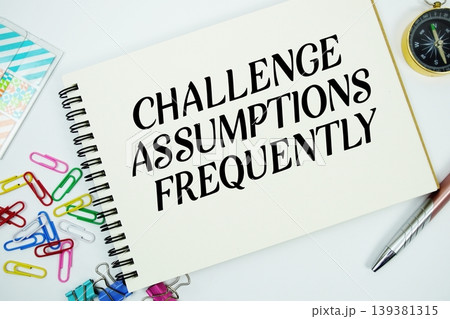 Challenge Assumptions Frequently text message written on notepad with stationery flat lay on white background Challenge Assumptions Frequently text message written on notepad with stationery flat lay on white background 139381315