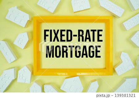 Fixed-Rate Mortgage text with house models on yellow background Fixed-Rate Mortgage text with house models on yellow background 139381321