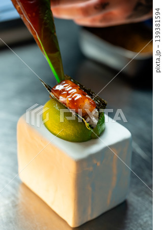 Sophisticated seafood plate arranged with lime and flavorful sauces on sleek ceramic surface Sophisticated seafood plate arranged with lime and flavorful sauces on sleek ceramic surface 139381594