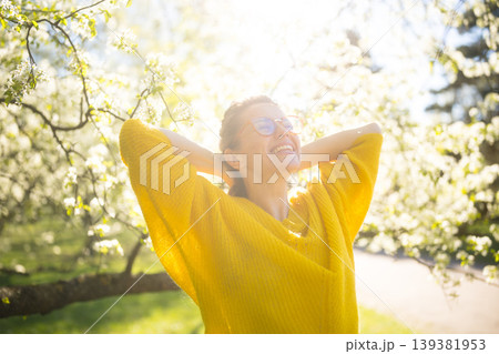 Happy Woman Enjoying Fresh Air in a Blooming Spring Park Happy Woman Enjoying Fresh Air in a Blooming Spring Park 139381953