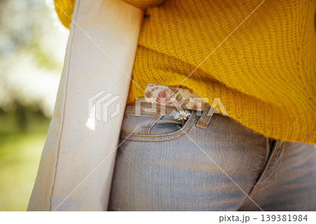 Casual Spring Fashion with Yellow Sweater and Daisy Detail 139381984
