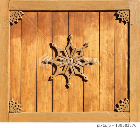Vintage wooden shutter with rustical naive handmade decor. Retro wood door with simple hand-carved decor. Timber shutters with folk-style carvings. Rustic artisan ornaments. Simple handmade motifs Vintage wooden shutter with rustical naive handmade decor. Retro wood door with simple hand-carved decor. Timber shutters with folk-style carvings. Rustic artisan ornaments. Simple handmade motifs 139382576