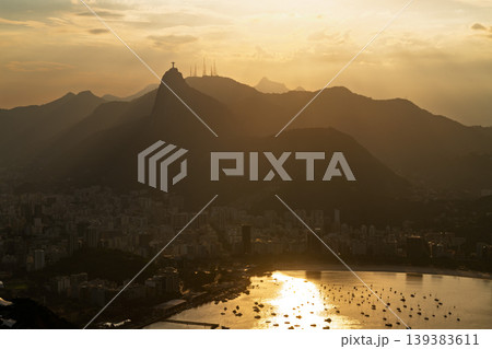 Majestic sunset over Rio de Janeiro city with warm golden light on bay and Corcovado mountain silhouette Majestic sunset over Rio de Janeiro city with warm golden light on bay and Corcovado mountain silhouette 139383611