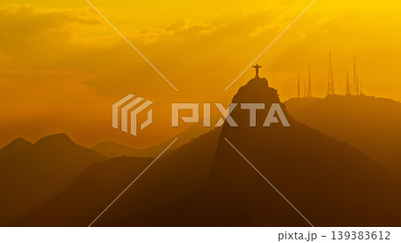 Majestic Christ Redeemer statue silhouette on mountain at sunset serene landscape in Rio de Janeiro Brazil 139383612