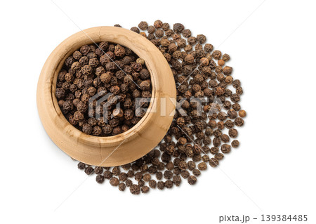 Black peppercorns or pepper in a wooden bowl isolated on a white background. Top view. Flat lay 139384485