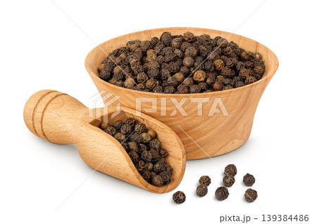 Black peppercorns or pepper in a wooden bowl and scoop isolated on a white background Black peppercorns or pepper in a wooden bowl and scoop isolated on a white background 139384486