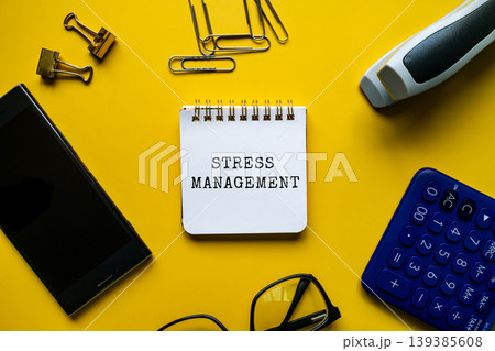 Stress Management text on notepad with glasses, calculator and smartphone on yellow desk, flat lay healthcare concept Stress Management text on notepad with glasses, calculator and smartphone on yellow desk, flat lay healthcare concept 139385608