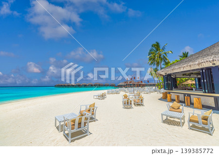 Exclusive Maldives beach luxury hobo style with barefoot elegance featuring rustic chic textures and a serene turquoise ocean background 139385772