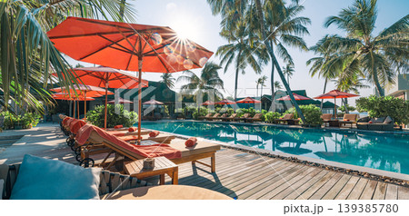 Tropical resort poolside umbrella palm trees sunny summer day exotic travel destination amazing luxury vacation background serene turquoise water swimming pool scenic coastal ocean scenery Tropical resort poolside umbrella palm trees sunny summer day exotic travel destination amazing luxury vacation background serene turquoise water swimming pool scenic coastal ocean scenery 139385780