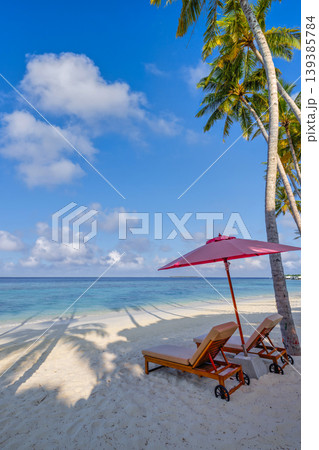 Exotic summer travel vacation landscape gorgeous tourism scenery tropical travel beach sunbeds umbrella palm trees peaceful ocean amazing turquoise water backdrop serene island paradise 139385784