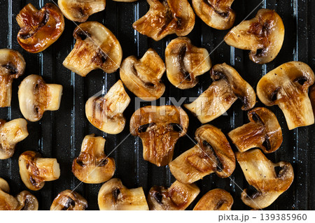 Appetizing Sizzling Grilled Mushrooms on Hot Grill Plate Texture. 139385960