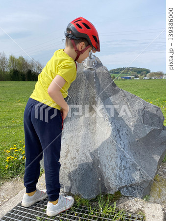 Child drinking fresh water during bicycle trip outdoors 139386000
