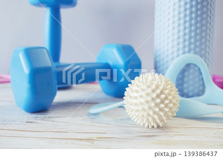 Fitness equipment for home yoga and pilates workouts with dumbbells, yoga ball, massage roller, resistance bands and skipping rope Fitness equipment for home yoga and pilates workouts with dumbbells, yoga ball, massage roller, resistance bands and skipping rope 139386437