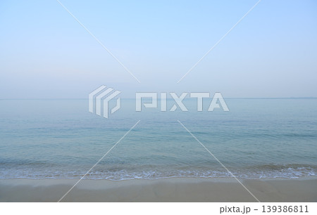 Calm clear sea meeting sandy beach horizon Calm clear sea meeting sandy beach horizon 139386811