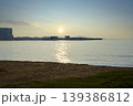 Serene sunrise over tropical ocean with beach and resort 139386812