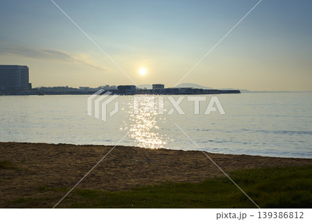 Serene sunrise over tropical ocean with beach and resort Serene sunrise over tropical ocean with beach and resort 139386812