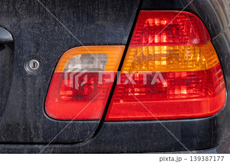 Bright lights from car headlights shine in a parking lot after sunset as vehicles are parked and the city sleeps Bright lights from car headlights shine in a parking lot after sunset as vehicles are parked and the city sleeps 139387177
