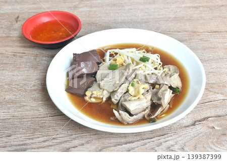stir-fried glass noodles with three stinky vegetables and shrimp couple squid on plate dipping spicy chili sauce 139387399