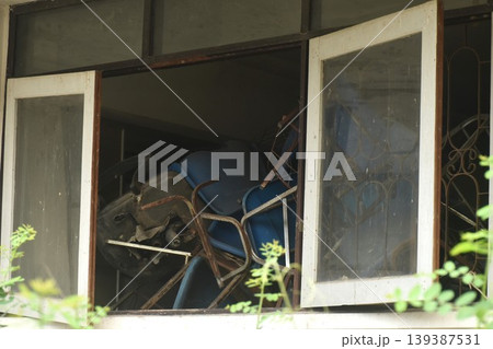 broken blue chair and table arranging block window in old school building on Thailand broken blue chair and table arranging block window in old school building on Thailand 139387531