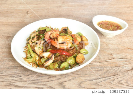 stir-fried glass noodles with three stinky vegetables and shrimp couple squid on plate dipping spicy chili sauce stir-fried glass noodles with three stinky vegetables and shrimp couple squid on plate dipping spicy chili sauce 139387535