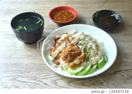 steamed rice topping chop crispy fried and boiled chicken on plate with chili sauce couple soup steamed rice topping chop crispy fried and boiled chicken on plate with chili sauce couple soup 139387538