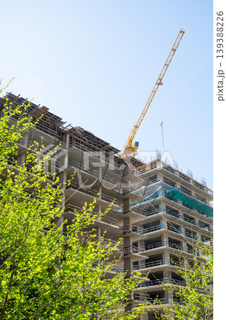 High-rise building under construction with tower crane, urban development and real estate concept High-rise building under construction with tower crane, urban development and real estate concept 139388226