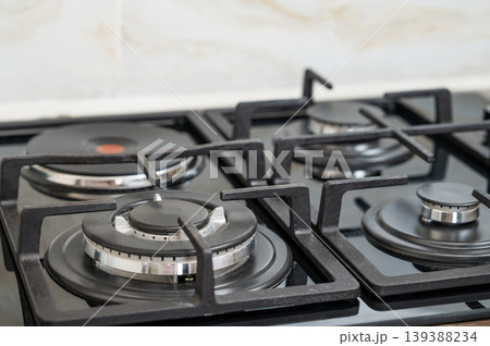 Close-up of modern gas and electric burners on a kitchen countertop. Close-up of modern gas and electric burners on a kitchen countertop. 139388234