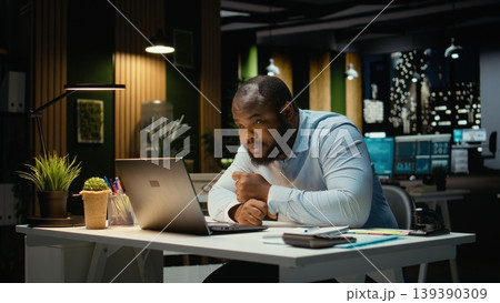 Male business manager leaning on desk showing symptoms of burnout and weariness. Sleep deprivation and work tension pushing limits with career difficulty and constant pressure. 139390309