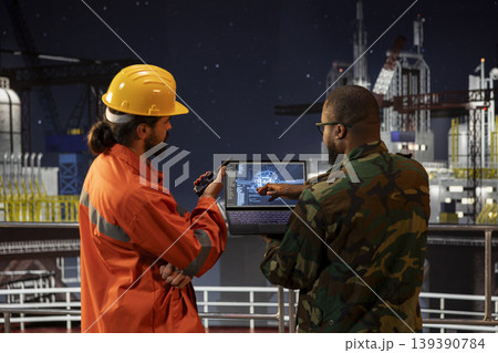 Military unit on offshore platform doling counter terrorism security using artificial intelligence neural networks technology. Army soldier guarding drilling barge, using AI machine learning program Military unit on offshore platform doling counter terrorism security using artificial intelligence neural networks technology. Army soldier guarding drilling barge, using AI machine learning program 139390784