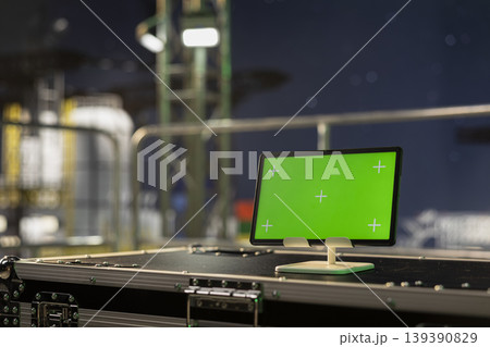 Green screen mockup tablet on offshore platform used for monitoring anomaly detection at night. Chroma key device on drilling ship deck used for managing subsea systems, close up shot 139390829
