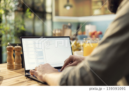 Adult programmer, developing web code, software systems on laptop, coding, debugging, data analysis, UX processes, and global network connectivity. Remote work in technology, high-tech. 139391091