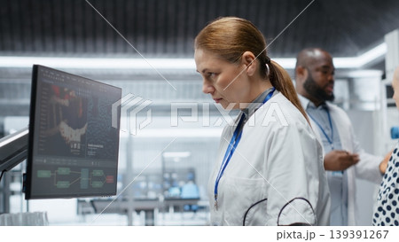 Female medic evaluates patient vitals for side effects during laboratory trial, recording dosage reactions and safety risks while supporting healthcare progress and biomedicine development. Camera B. 139391267