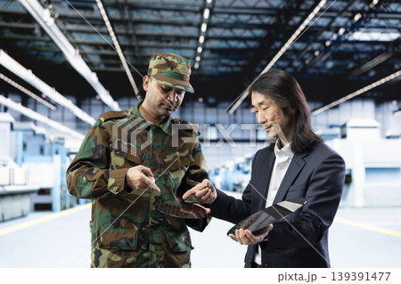 Evaluating hardware, microchip production and Asian man with army personnel in industrial plant. Doing factory tour, semiconductor substrates and military defense contractor with tech expert Evaluating hardware, microchip production and Asian man with army personnel in industrial plant. Doing factory tour, semiconductor substrates and military defense contractor with tech expert 139391477