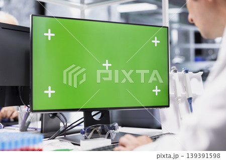 Close up of chroma key display with researcher conducting experiment with tools in lab, scientific work represents biotechnology, bioengineering and healthcare innovation for future medicine. 139391598