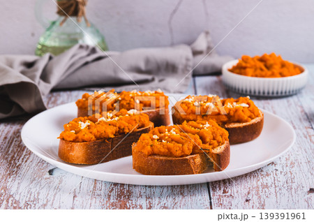 Carrot hummus sandwiches on a plate on the table Carrot hummus sandwiches on a plate on the table 139391961