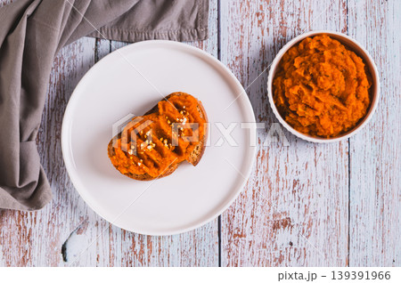 Closeup of carrot hummus sandwiches on a plate on the table top view Closeup of carrot hummus sandwiches on a plate on the table top view 139391966