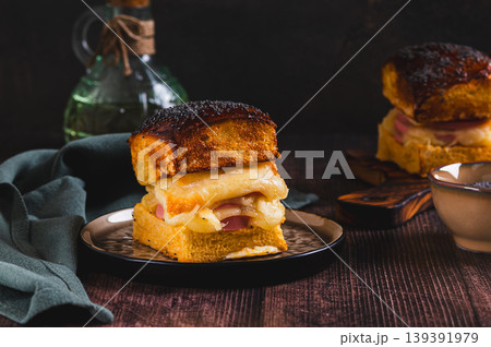 Baked burgers with cheese, sausage, sprinkled with poppy seeds on a plate on the table Baked burgers with cheese, sausage, sprinkled with poppy seeds on a plate on the table 139391979