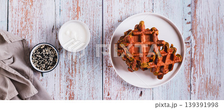 Homemade Belgian beetroot waffles on a plate on the table top view web banner Homemade Belgian beetroot waffles on a plate on the table top view web banner 139391998