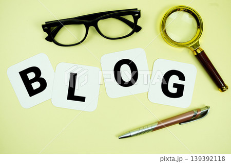 BLOG alphabet letters with magnifying glass, eye glasses and pen on yellow background 139392118