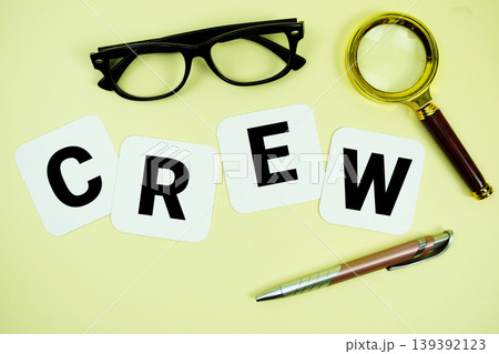 CREW alphabet letters with magnifying glass, eye glasses and pen on yellow background CREW alphabet letters with magnifying glass, eye glasses and pen on yellow background 139392123