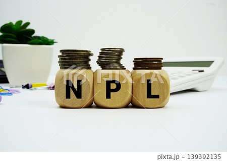 Stack of coins with wood blocks with "NPL (Non Performing Loans)" Financial concept 139392135