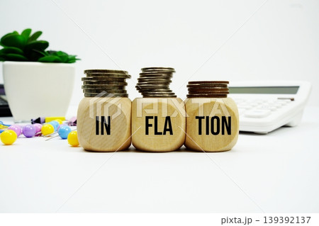 Stack of coins with wood blocks with "INFLATION" Financial concept Stack of coins with wood blocks with "INFLATION" Financial concept 139392137