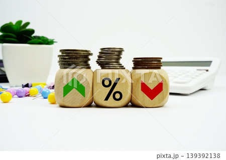 Stack of coins with wood blocks with Percent And Up Or Down Arrow Financial concept Stack of coins with wood blocks with Percent And Up Or Down Arrow Financial concept 139392138