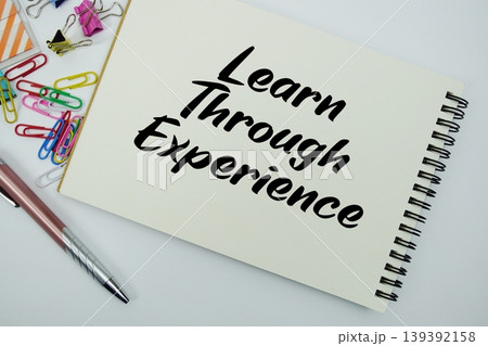 Learn Through Experience text message written on notepad with stationery flat lay on white background Learn Through Experience text message written on notepad with stationery flat lay on white background 139392158