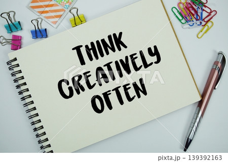 Think Creatively Often text message written on notepad with stationery flat lay on white background Think Creatively Often text message written on notepad with stationery flat lay on white background 139392163